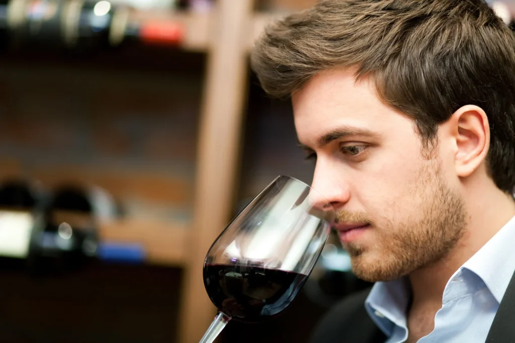 Man tasting a glass of red wine